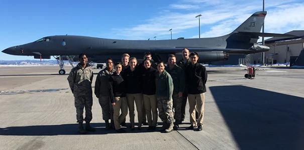 Cadets stand in front of aircraft.